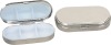 oval shaped metal pill box in 3 case with mirror